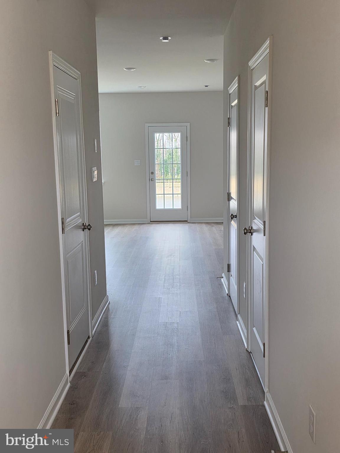 57 Alexander Way Westampton, NJ 08060 - Photo 3 of 27 an empty room with wooden floor and a window