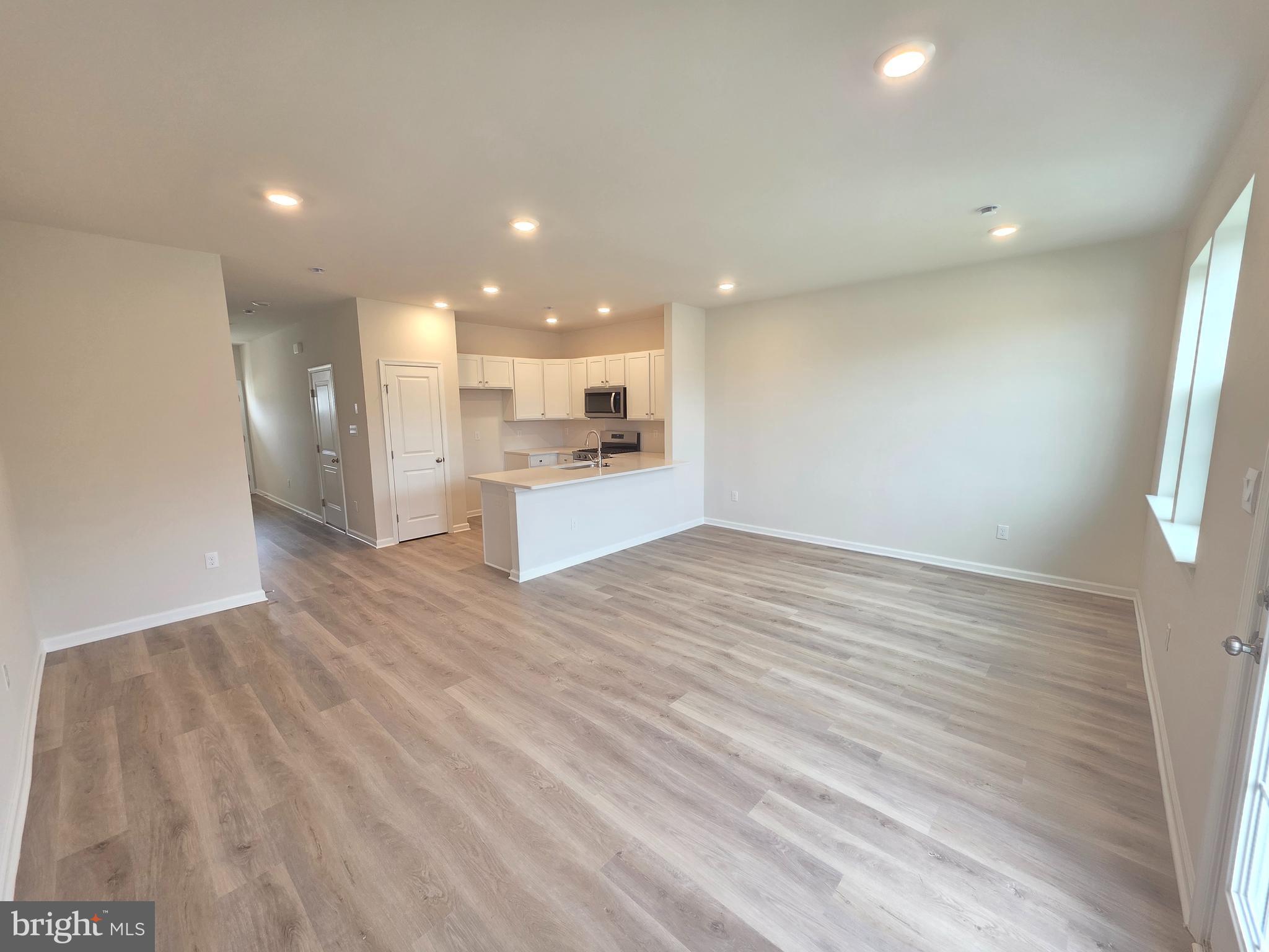 57 Alexander Way Westampton, NJ 08060 - Photo 5 of 27 an empty room with wooden floor and windows