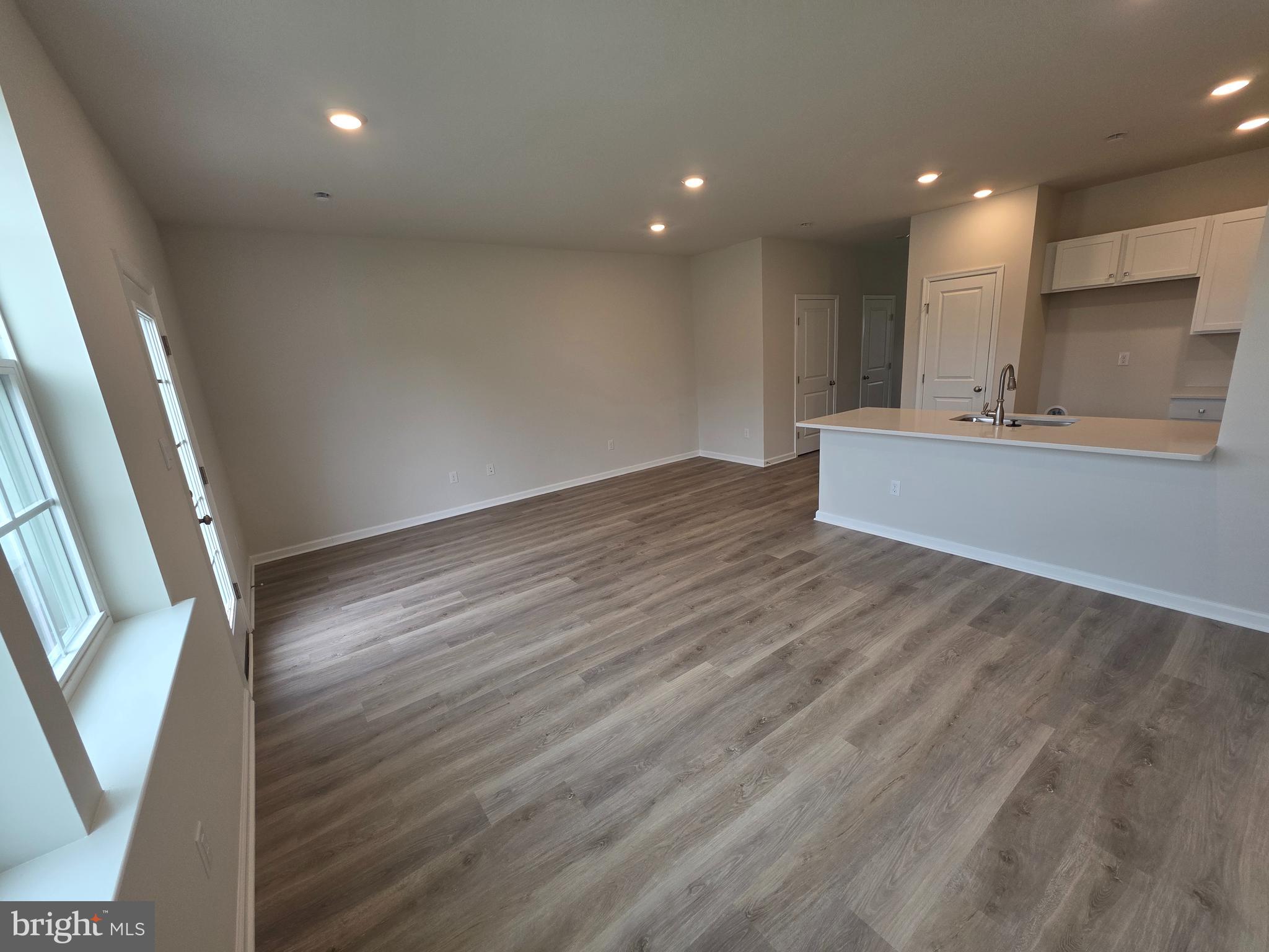 57 Alexander Way Westampton, NJ 08060 - Photo 6 of 27 an empty room with wooden floor and windows