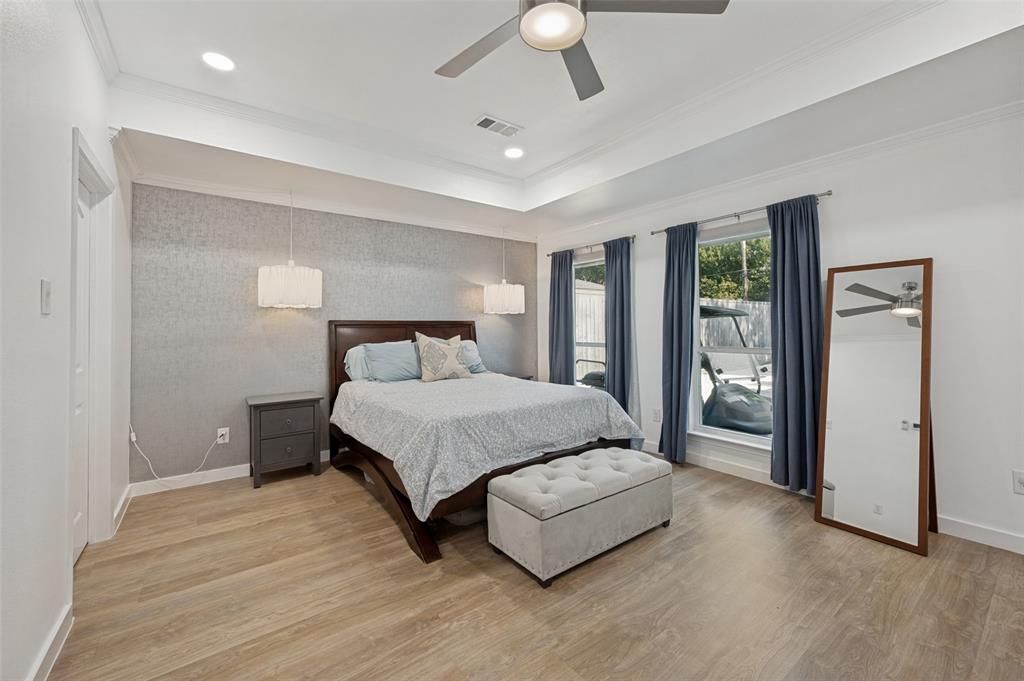 3619 Merrell Road Dallas, TX 75229 - Photo 20 of 26 Recessed lighting and a ceiling fan illuminate the room, featuring wood-finish flooring and a tray ceiling