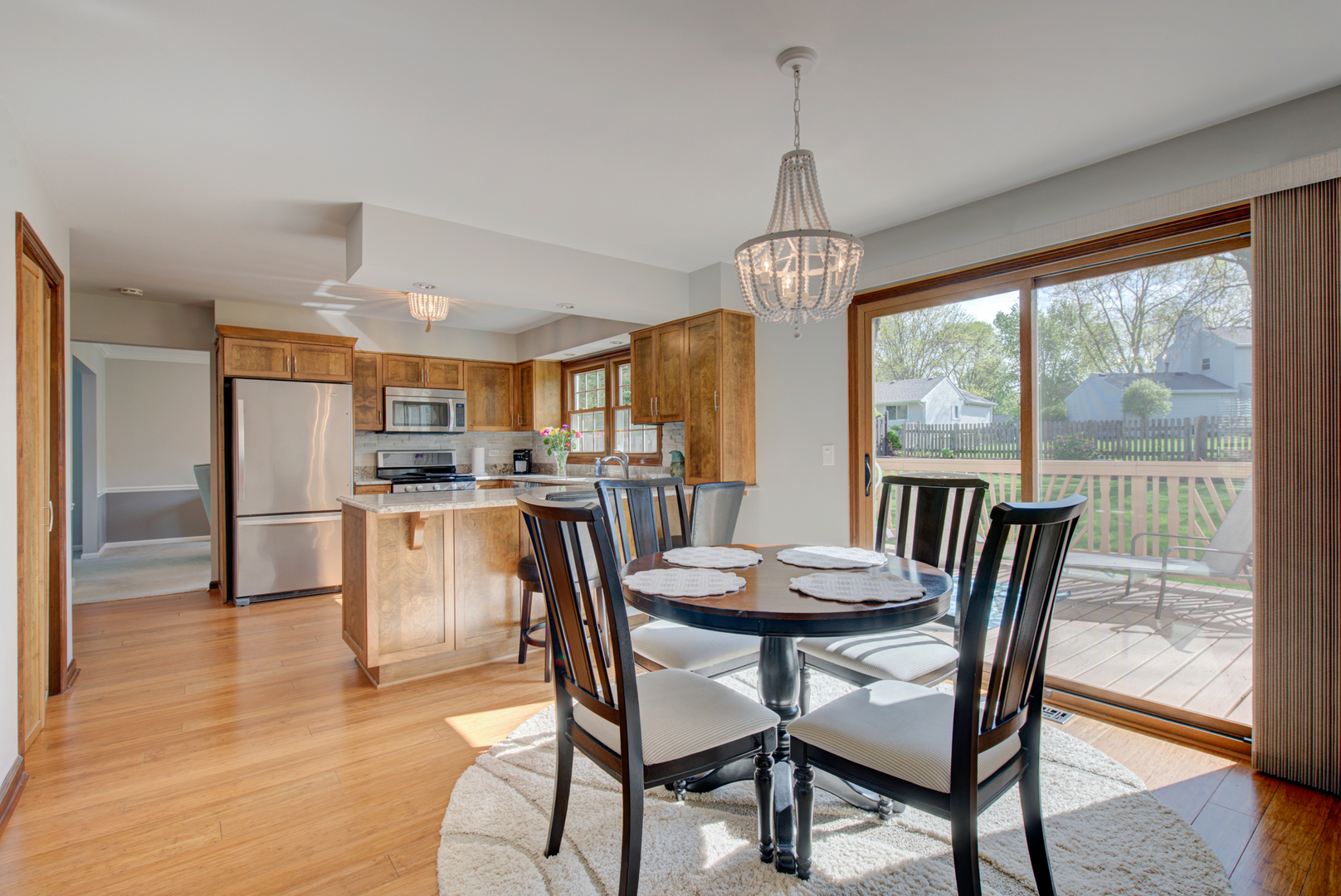 1710 Fender Road Naperville, IL 60565 - Photo 9 of 46 a dining room with furniture a chandelier and wooden floor