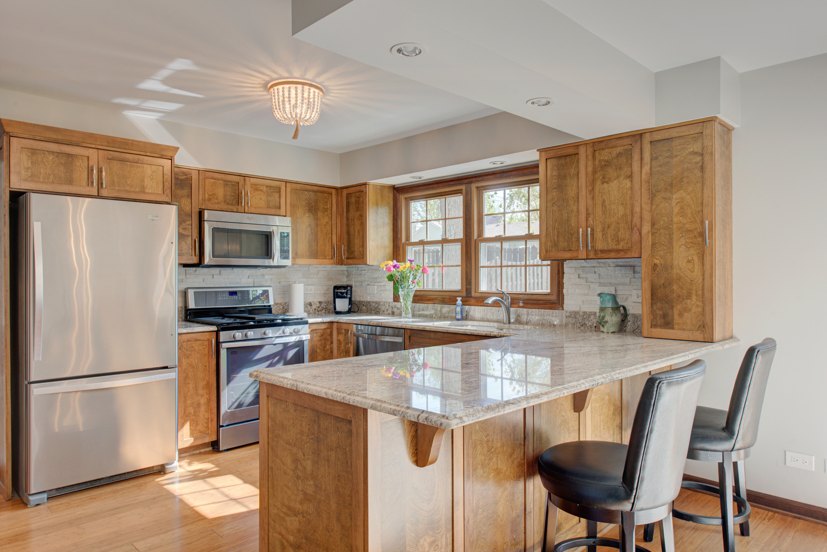 1710 Fender Road Naperville, IL 60565 - Photo 10 of 46 a kitchen with stainless steel appliances granite countertop a refrigerator a stove a sink a dining table and chairs