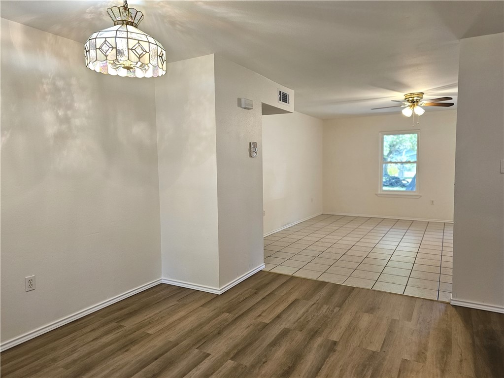 3121 Lenore Avenue Ingleside, TX 78362 - Photo 11 of 24 an empty room with wooden floor chandelier and windows