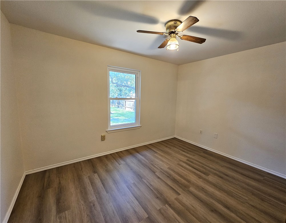 3121 Lenore Avenue Ingleside, TX 78362 - Photo 17 of 24 wooden floor in an empty room with a window