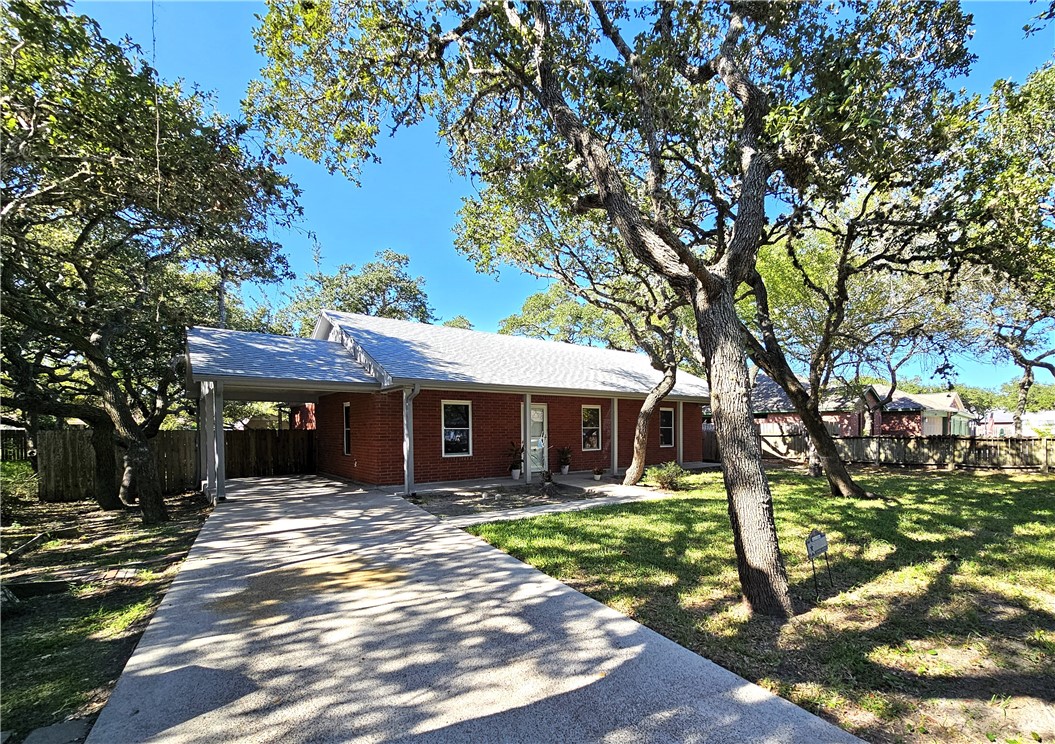 3121 Lenore Avenue Ingleside, TX 78362 - Photo 2 of 24 a front view of a house with garden