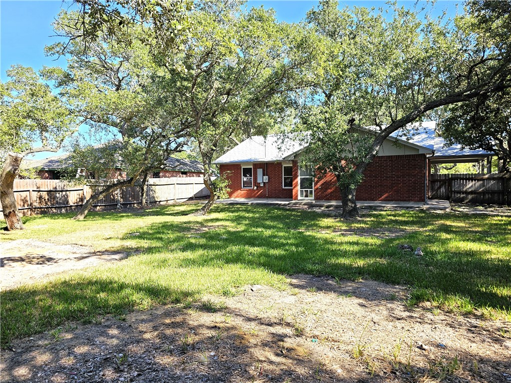 3121 Lenore Avenue Ingleside, TX 78362 - Photo 22 of 24 a view of a house with a big yard and large trees