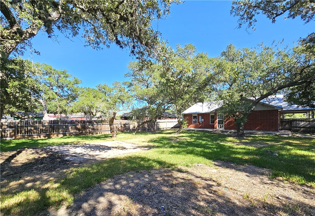 3121 Lenore Avenue Ingleside, TX 78362 - Photo 23 of 24 a backyard of a house with yard and outdoor seating