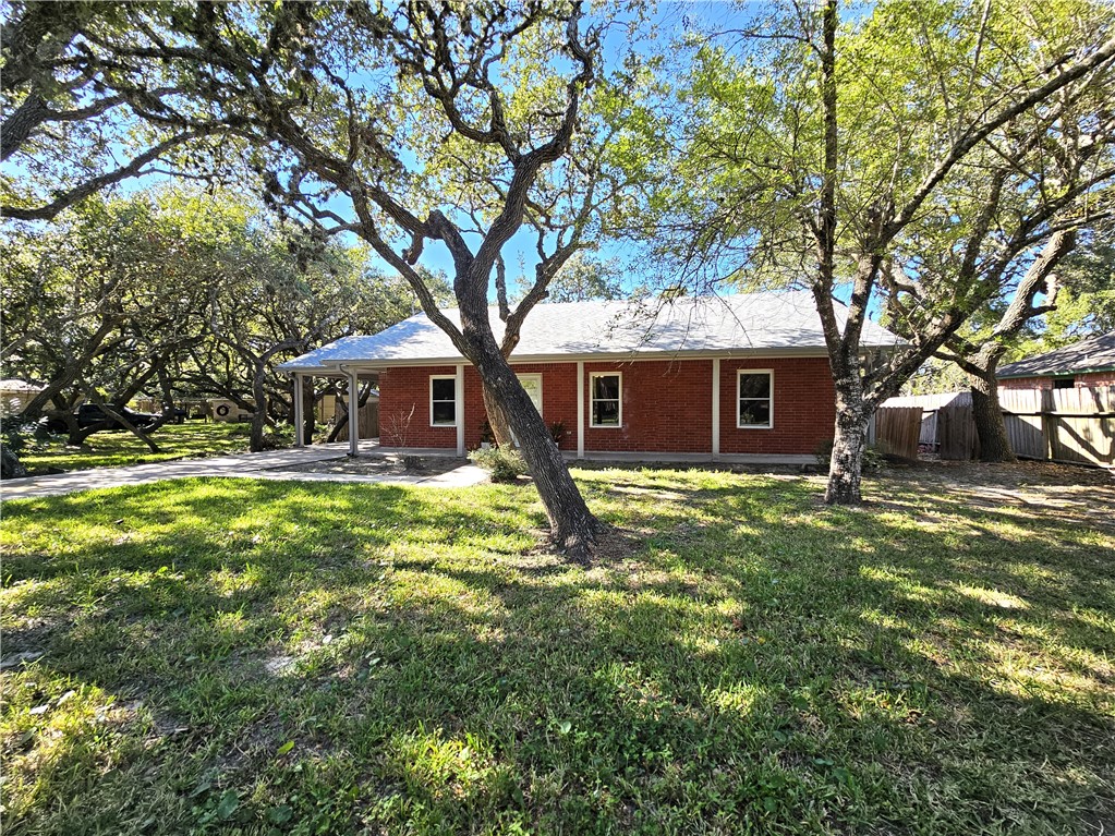3121 Lenore Avenue Ingleside, TX 78362 - Photo 3 of 24 a front view of a house with a garden