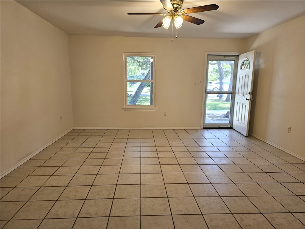 3121 Lenore Avenue Ingleside, TX 78362 - Photo 4 of 24 an empty room with windows and fan