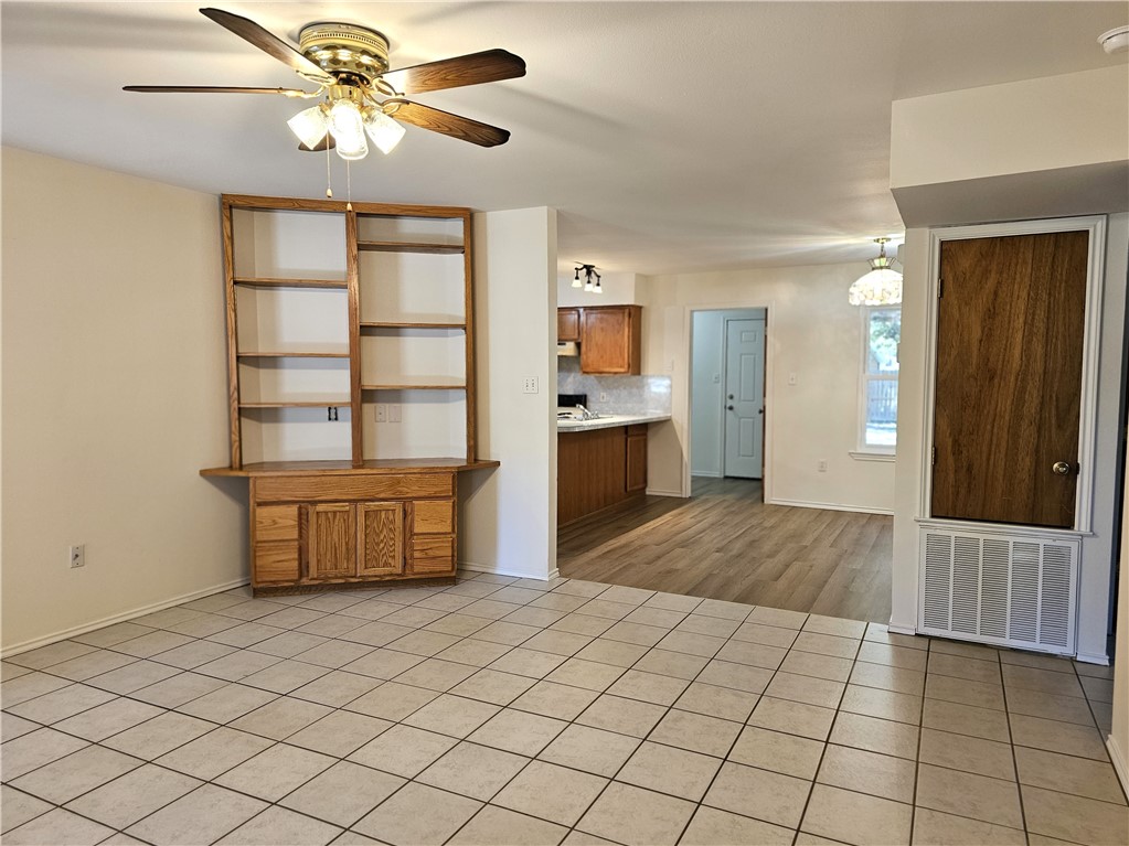 3121 Lenore Avenue Ingleside, TX 78362 - Photo 6 of 24 a spacious bedroom with a bed and a chandelier