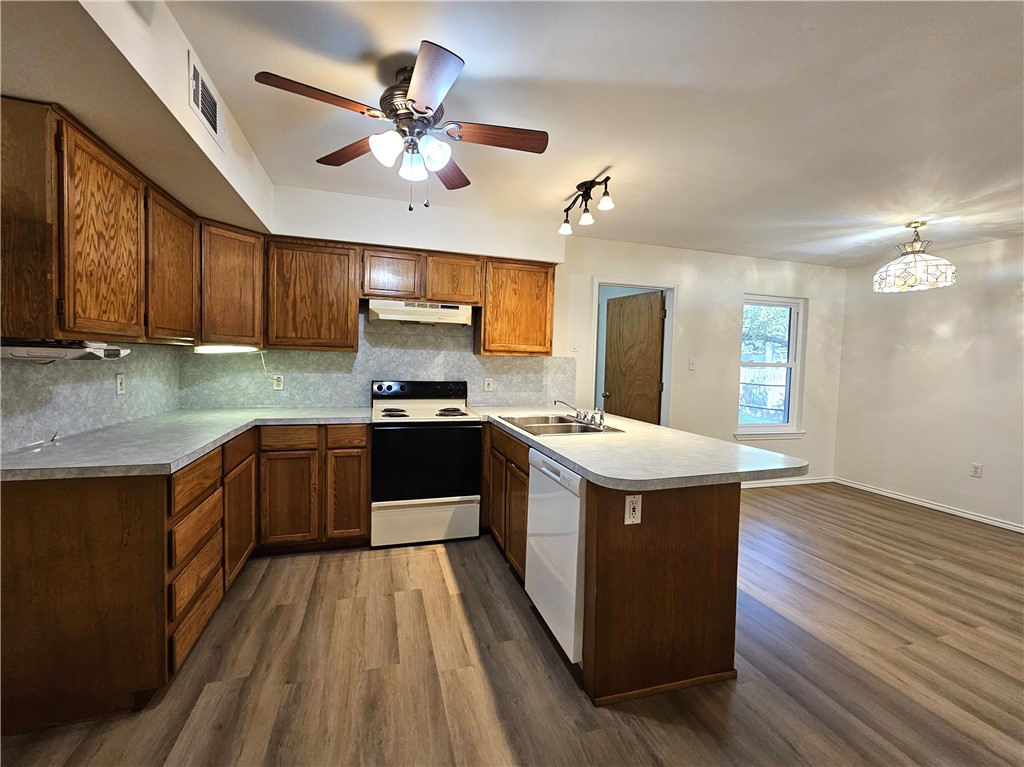 3121 Lenore Avenue Ingleside, TX 78362 - Photo 8 of 24 a kitchen with stainless steel appliances kitchen island granite countertop wooden floors and sink