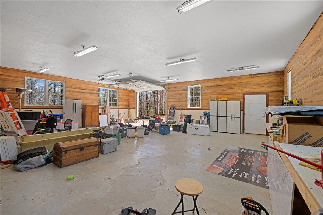 204 Riverlake Road Fair Play, SC 29643 - Photo 43 of 50 This spacious garage offers ample room for vehicles and storage, featuring durable concrete flooring.
