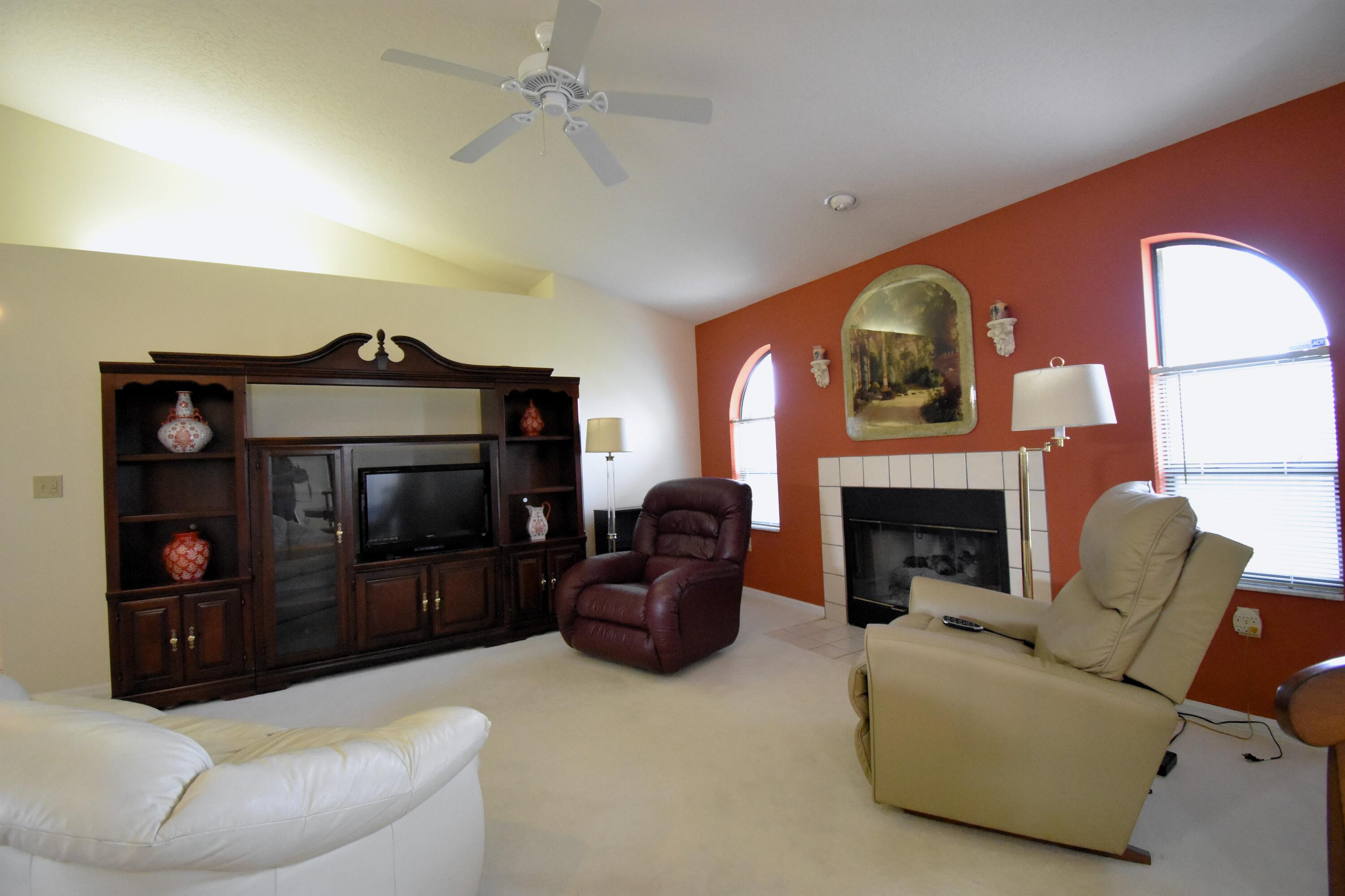 1920 Glen Meadows Circle Melbourne, FL 32935 - Photo 12 of 19 a living room with furniture and a fireplace