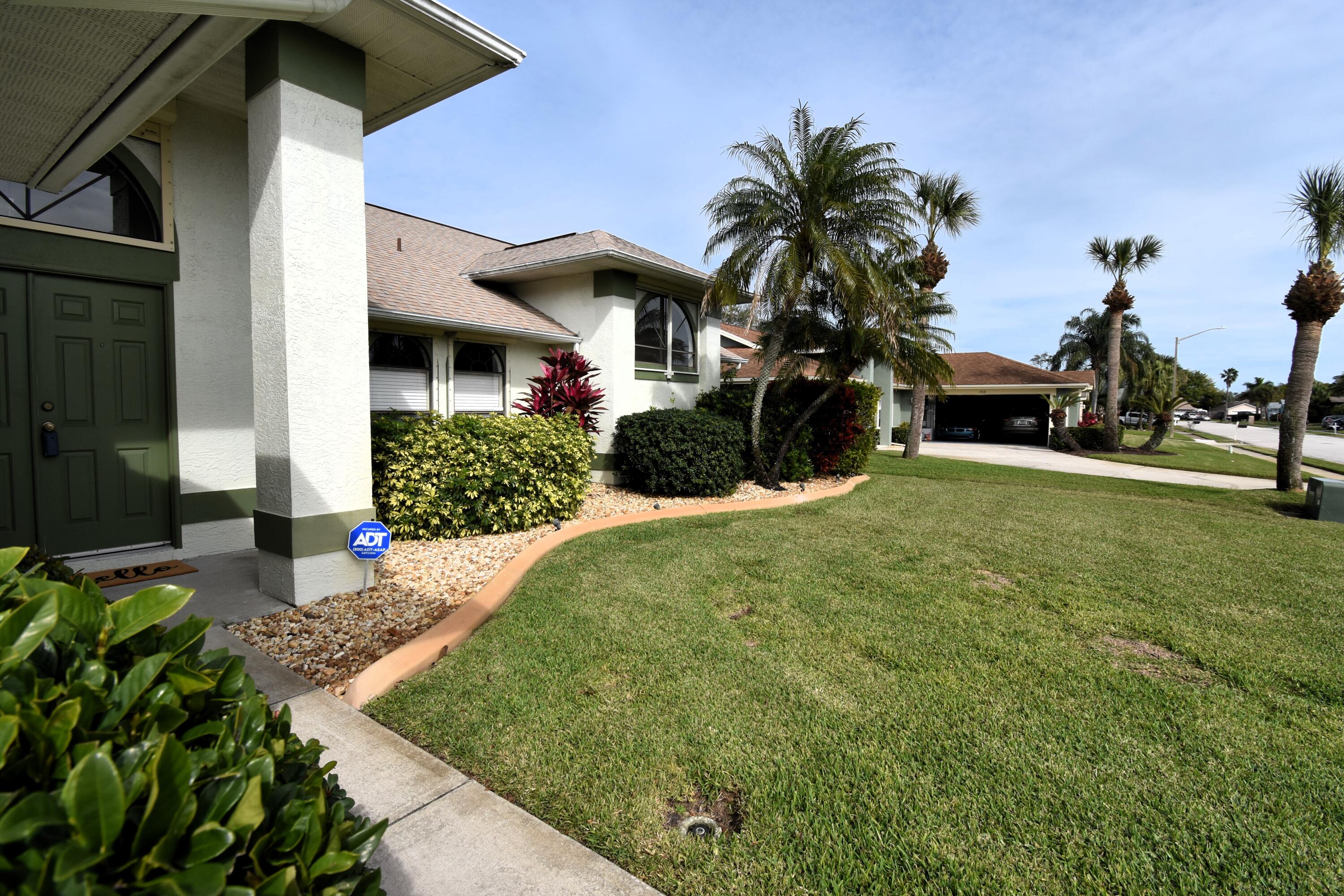1920 Glen Meadows Circle Melbourne, FL 32935 - Photo 2 of 19 a front view of a house with a yard