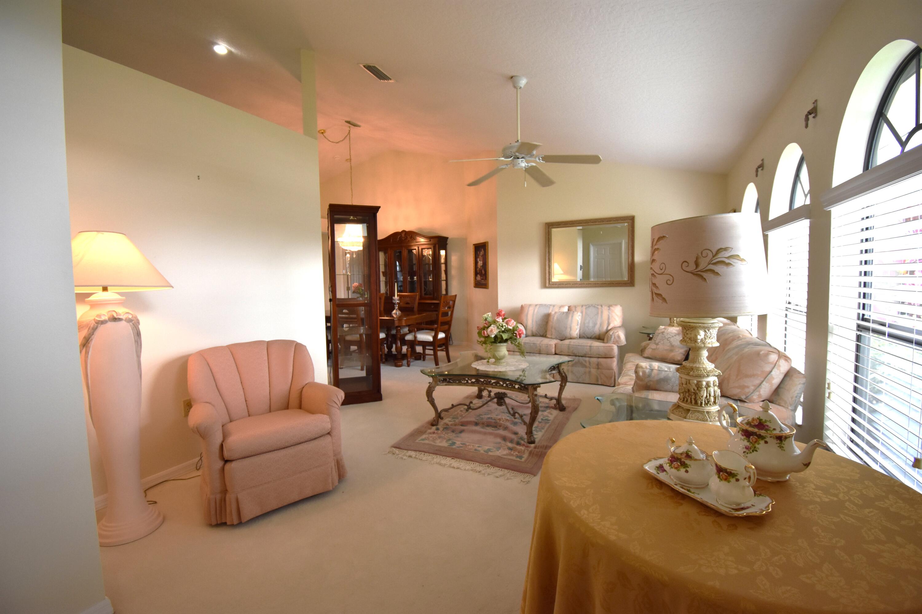 1920 Glen Meadows Circle Melbourne, FL 32935 - Photo 3 of 19 a living room with furniture and a lamp