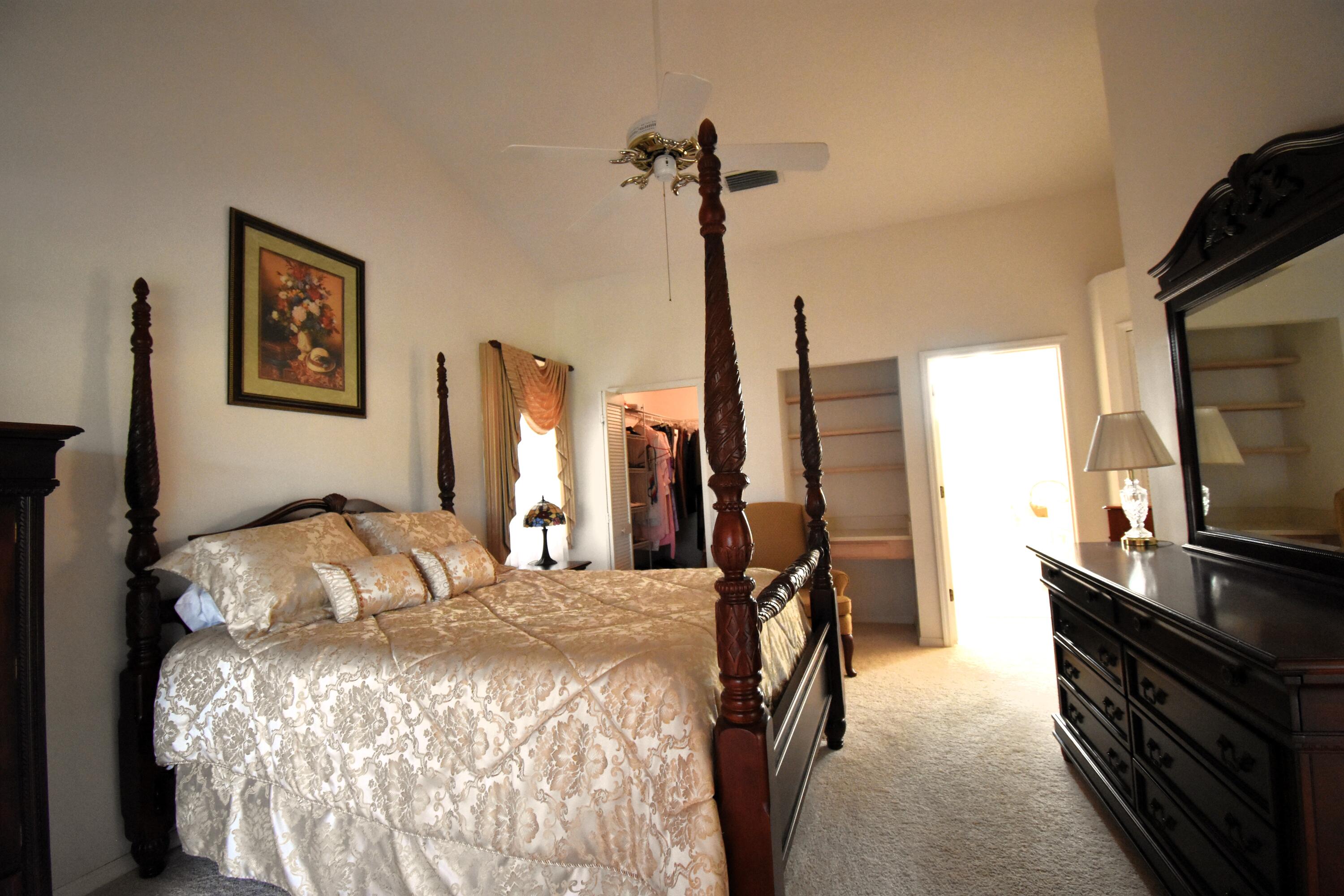 1920 Glen Meadows Circle Melbourne, FL 32935 - Photo 7 of 19 a bedroom with a bed window and a flat screen tv