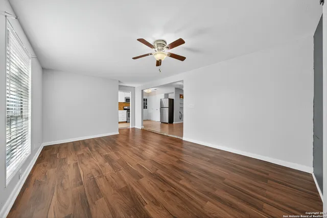wooden floor in an empty room with a window