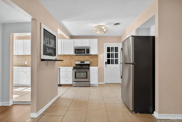 a kitchen with stainless steel appliances cabinets and a refrigerator