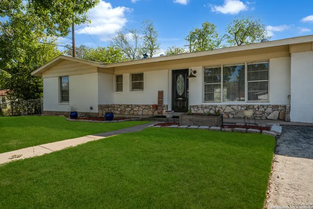 a front view of house with yard and outdoor seating