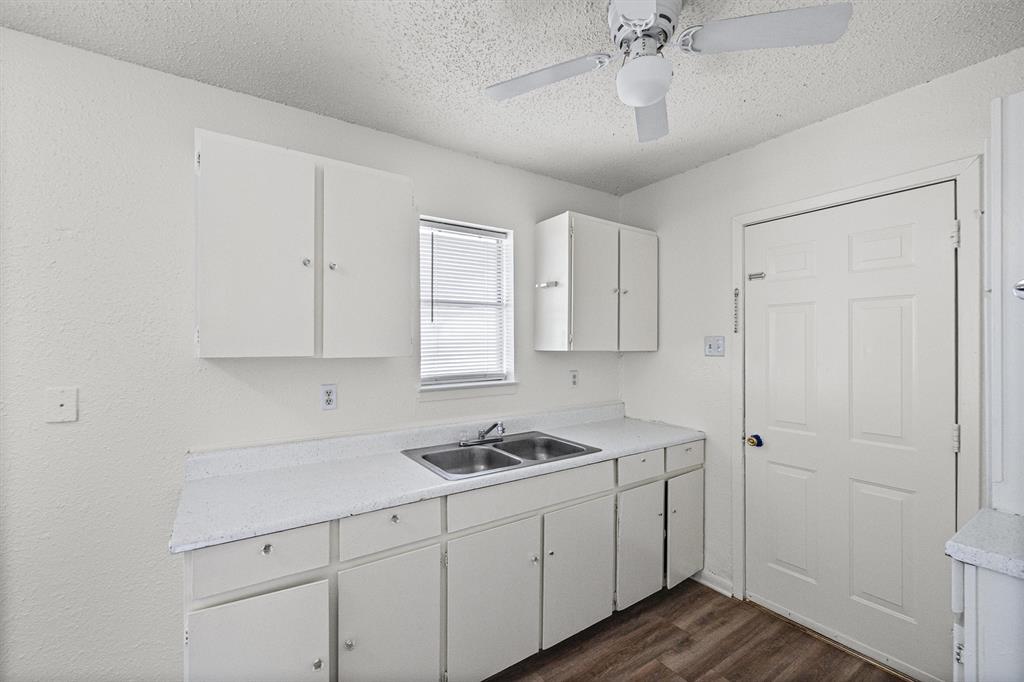 500 Highway 22 Meridian, TX 76665 - Photo 11 of 28 a kitchen with white cabinets and sink