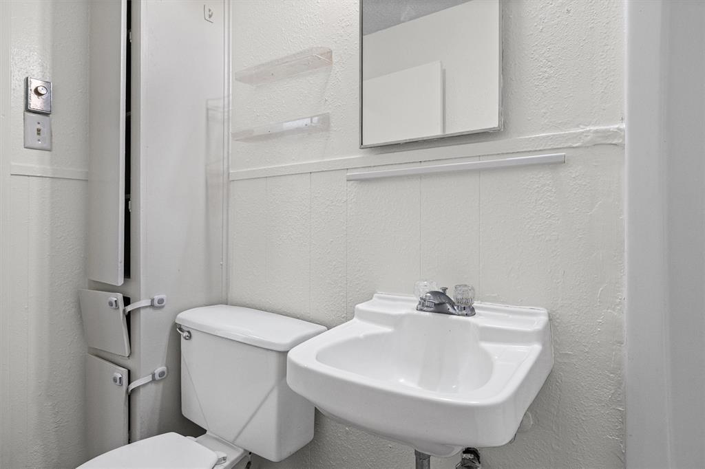 500 Highway 22 Meridian, TX 76665 - Photo 17 of 28 a bathroom with a sink a toilet and a mirror