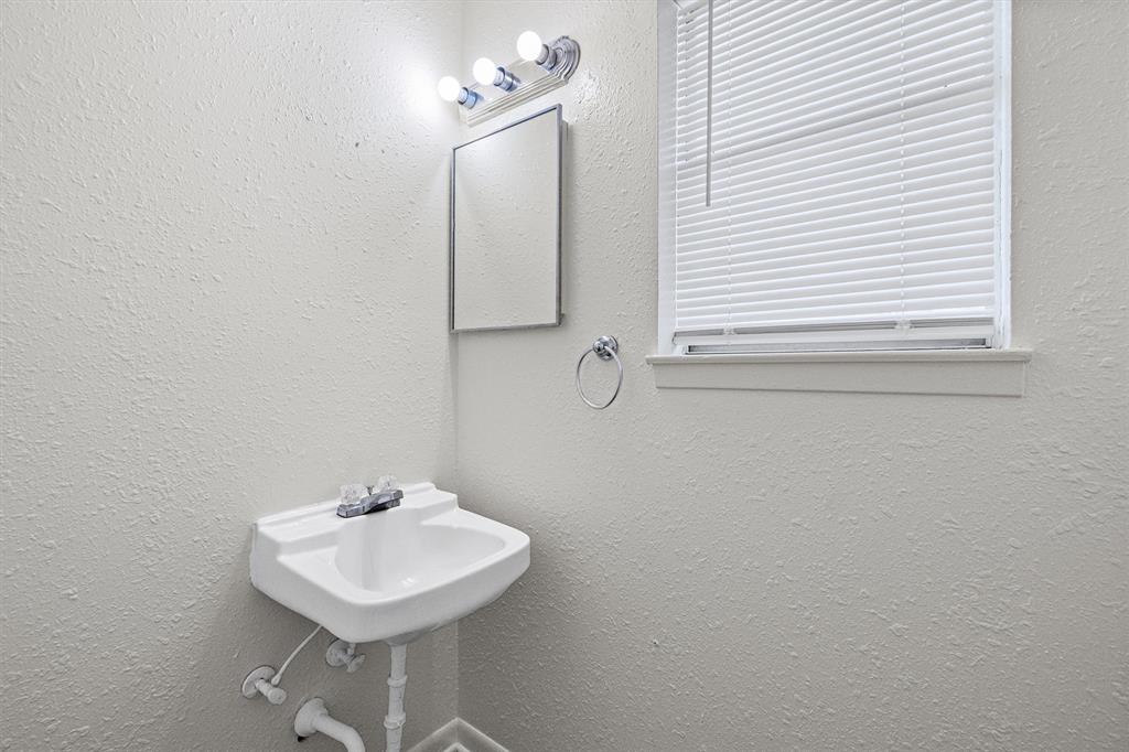 500 Highway 22 Meridian, TX 76665 - Photo 21 of 28 a bathroom with a sink a mirror and a window