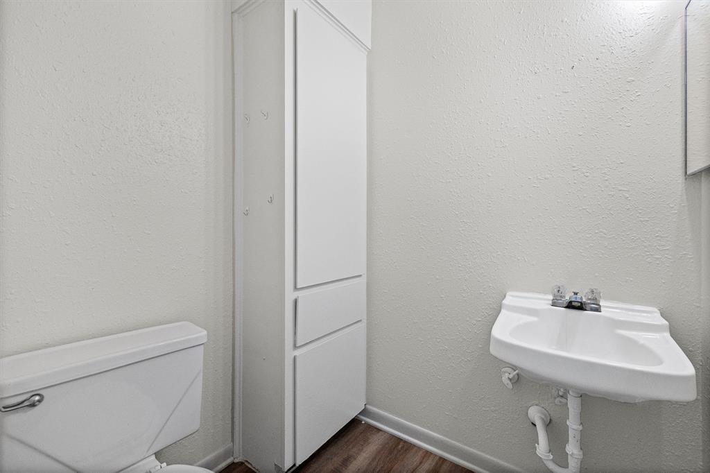 500 Highway 22 Meridian, TX 76665 - Photo 22 of 28 a bathroom with a sink a toilet and a mirror
