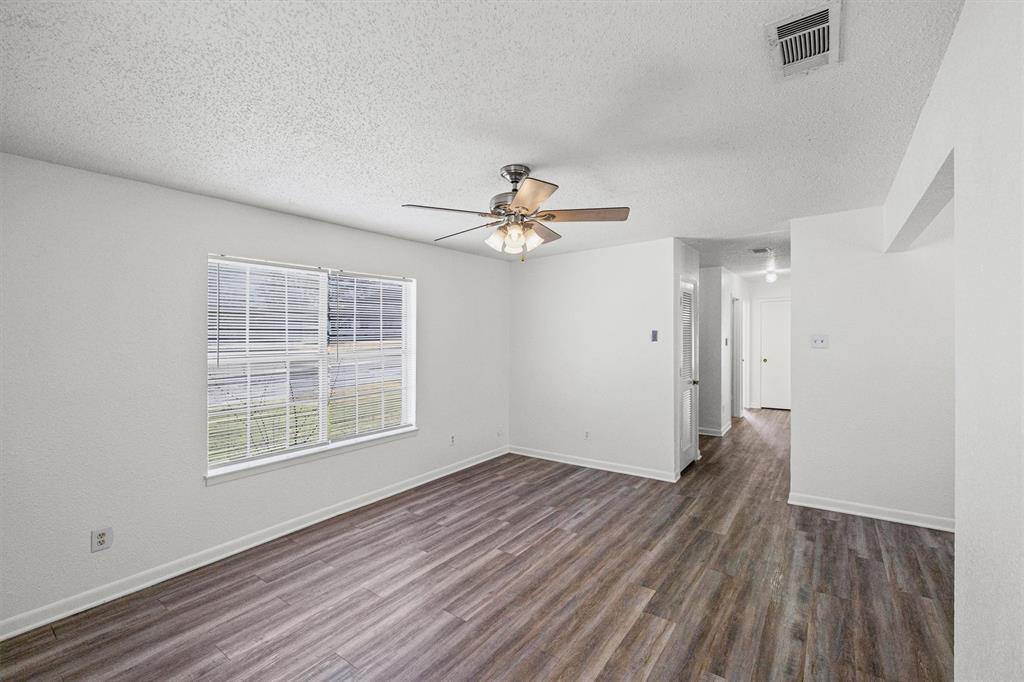 500 Highway 22 Meridian, TX 76665 - Photo 7 of 28 wooden floor in an empty room with a window