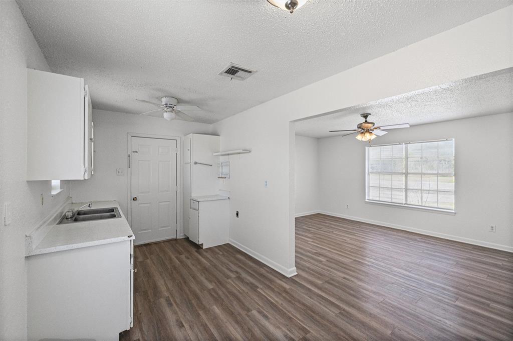 500 Highway 22 Meridian, TX 76665 - Photo 10 of 28 a view of workspace with wooden floor ceiling fan and window