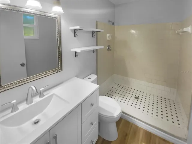 a bathroom with a sink toilet and shower