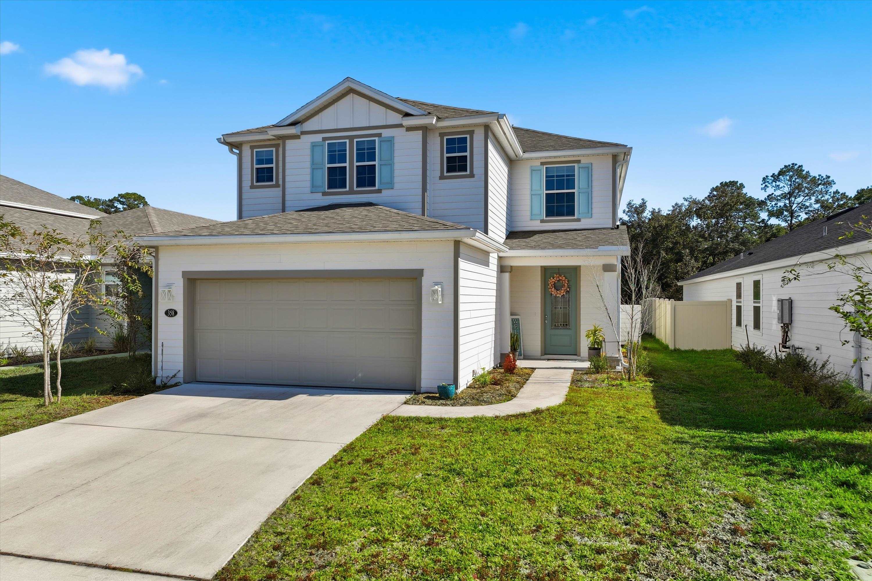358 Rambling Brk Trail St. Johns, FL 32259 - Photo 2 of 39 a front view of a house with a yard and garage