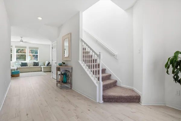 a view of entryway and hall with wooden floor