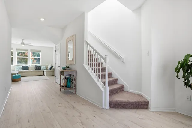 a view of entryway and hall with wooden floor