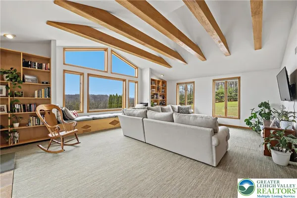 a living room with furniture a rug and a chandelier