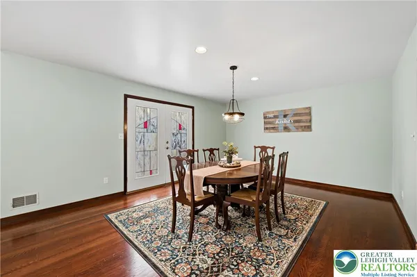 a view of a livingroom with furniture and hardwood floor
