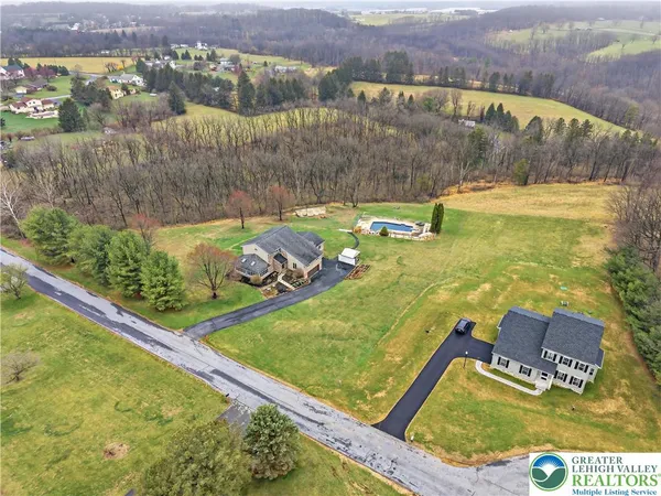 an aerial view of a house with a swimming pool