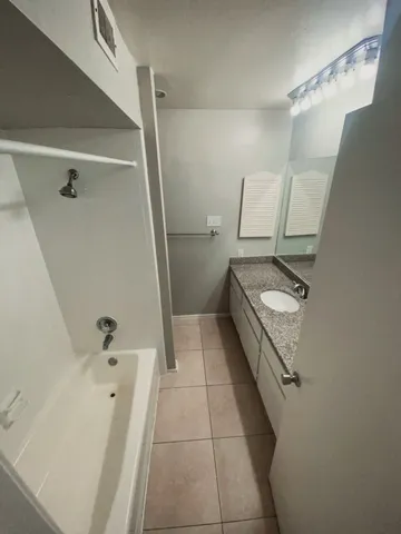 a bathroom with a tub a toilet and a shower