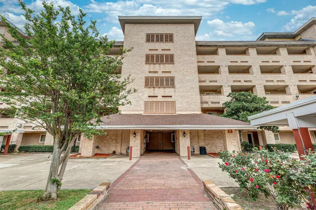 front view of a building with a garden