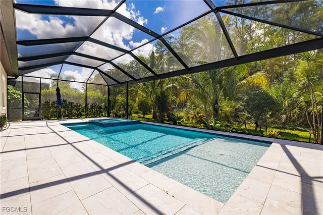 a view of a backyard with table and chairs under an umbrella