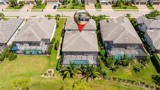 a view of a house with a yard and a pond