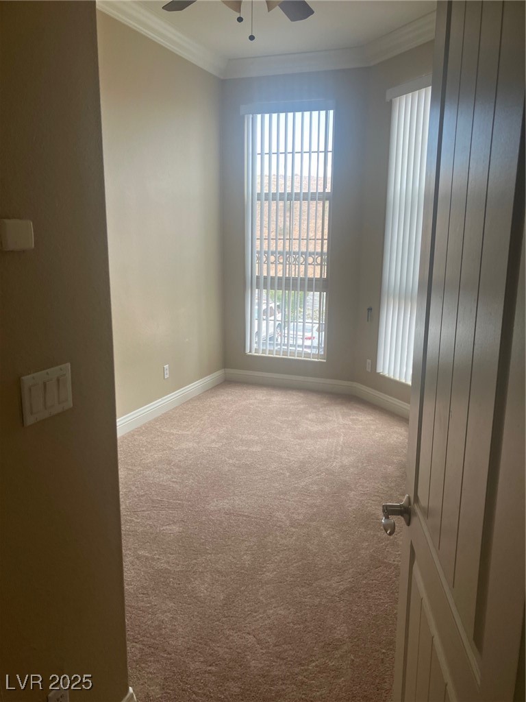 32 Via Vasari, Unit 103 Henderson, NV 89011 - Photo 11 of 26 Carpeted empty room featuring baseboards, ornamental molding, ceiling fan, and plenty of natural light