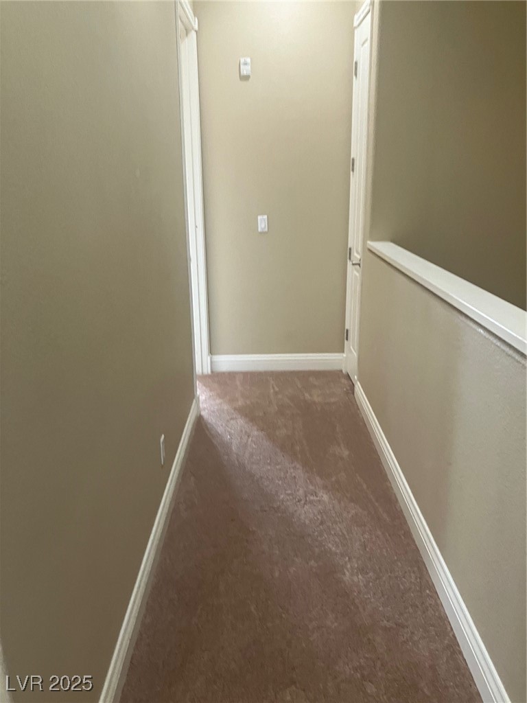 32 Via Vasari, Unit 103 Henderson, NV 89011 - Photo 15 of 26 Hallway featuring carpet floors and baseboards