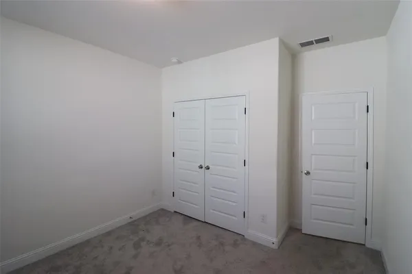 an empty room with closet area
