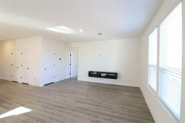 a view of a room with wooden floor