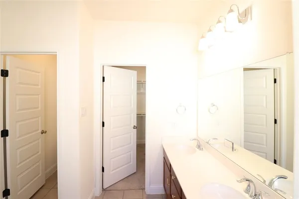 a bathroom with a tub sink and mirror