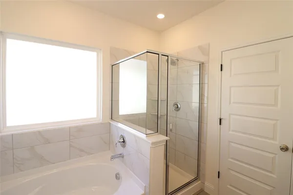 a bathroom with a bathtub and a shower