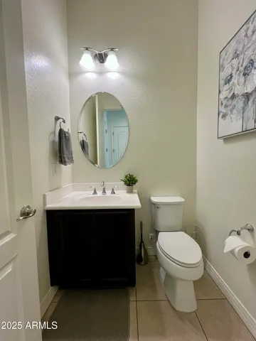 a view of a house with a small yard and flower plants