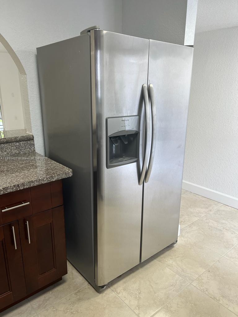 2670 West 76th Street, Unit 101 Hialeah, FL 33016 - Photo 11 of 35 a metallic refrigerator freezer sitting in a kitchen