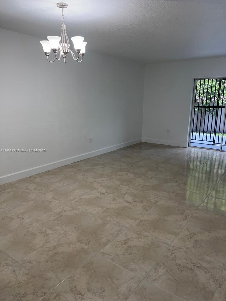 2670 West 76th Street, Unit 101 Hialeah, FL 33016 - Photo 2 of 35 a view of a chandelier in big room