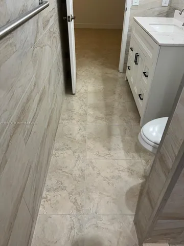 a bathroom with a toilet a sink and mirror